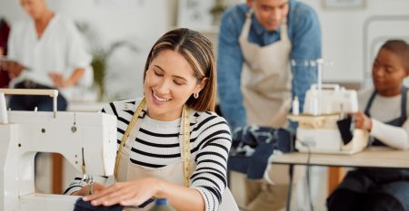 happy-and-smiling-female-seamstress-working-on-des-2026-01-09-10-41-44-utc